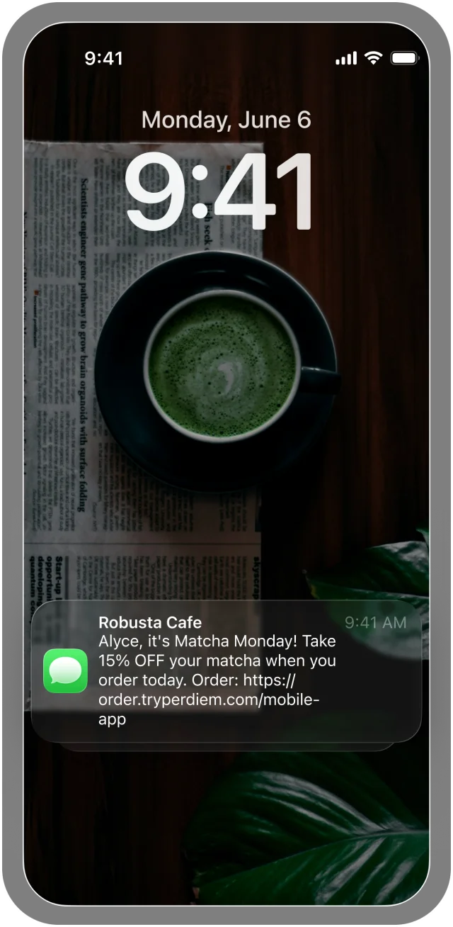Phone lock screen showing an SMS from Robusta Cafe: Alyce, it's Matcha Monday! Take 15% off your matcha when you order today.